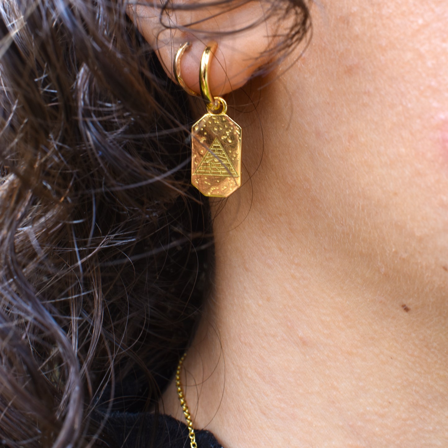 Woman wearing Ra / Horus earrings.