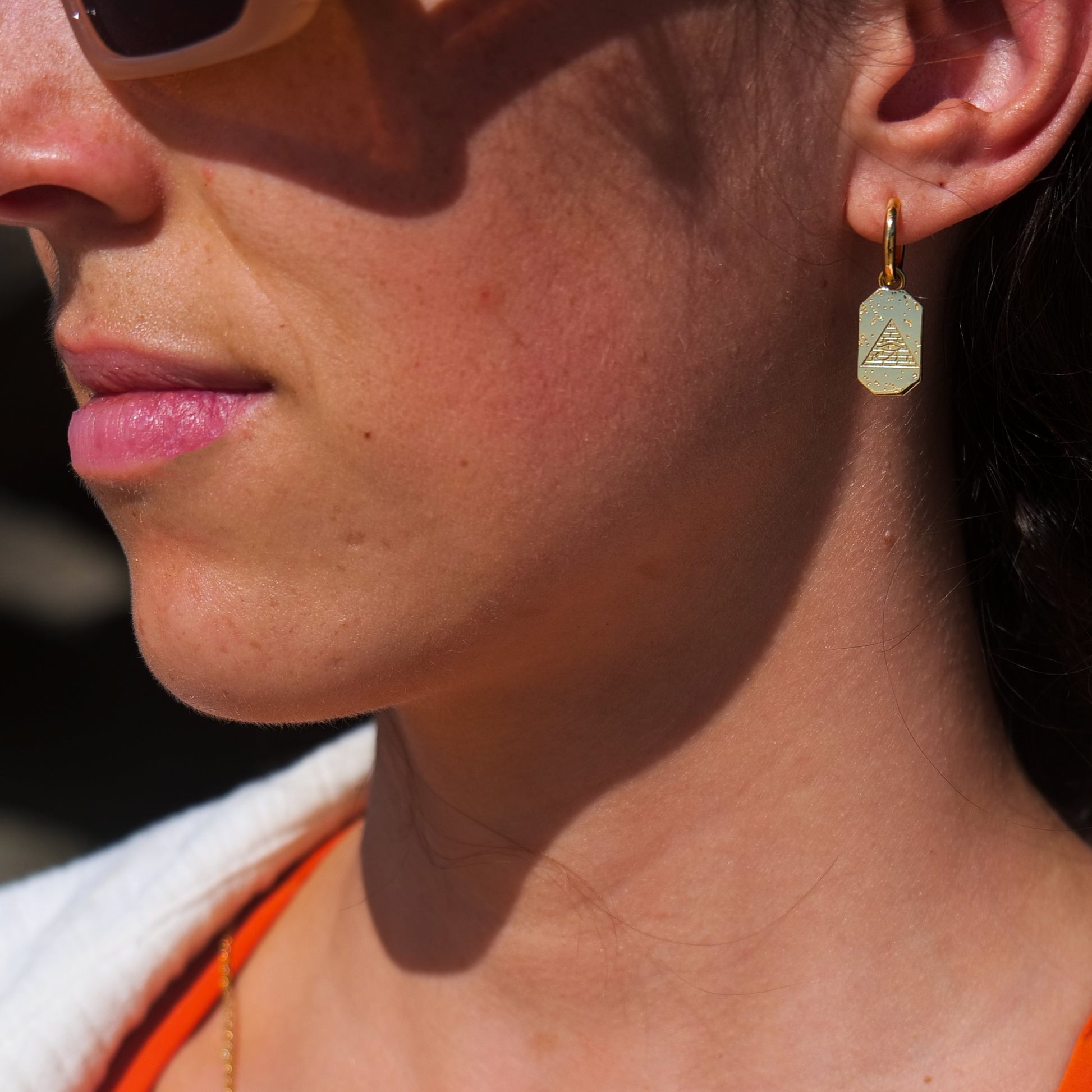 Woman wearing eye of Ra earring.